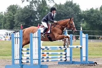 Carlye and Ailish jumping at a show