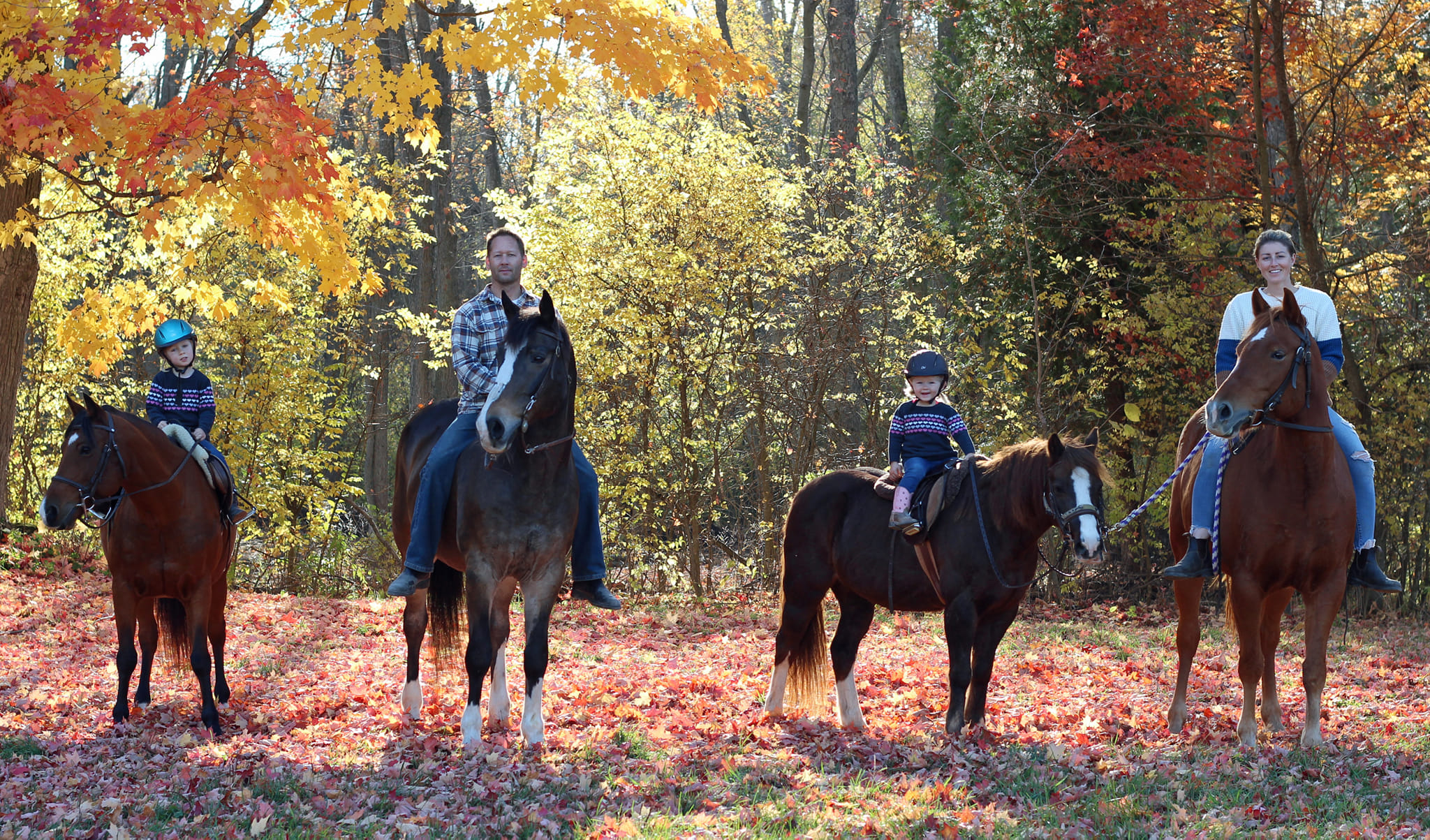 The Bowen family riding in autumn
